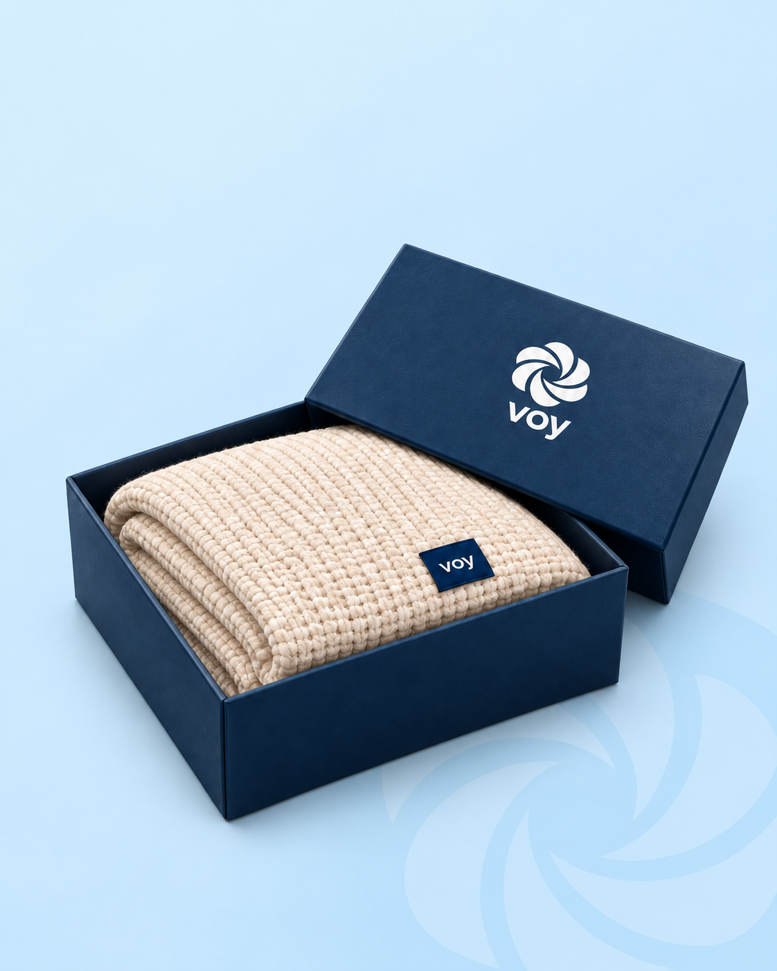 Cream Voy blanket presented in an open navy Voy box